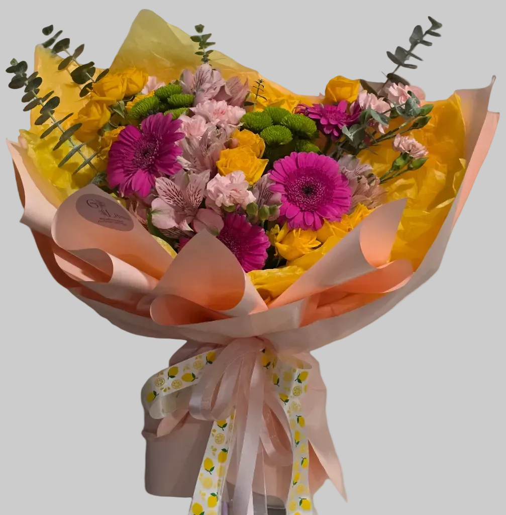 Colorful spring flower bouquet with yellow roses, pink gerberas, and fresh seasonal blooms.