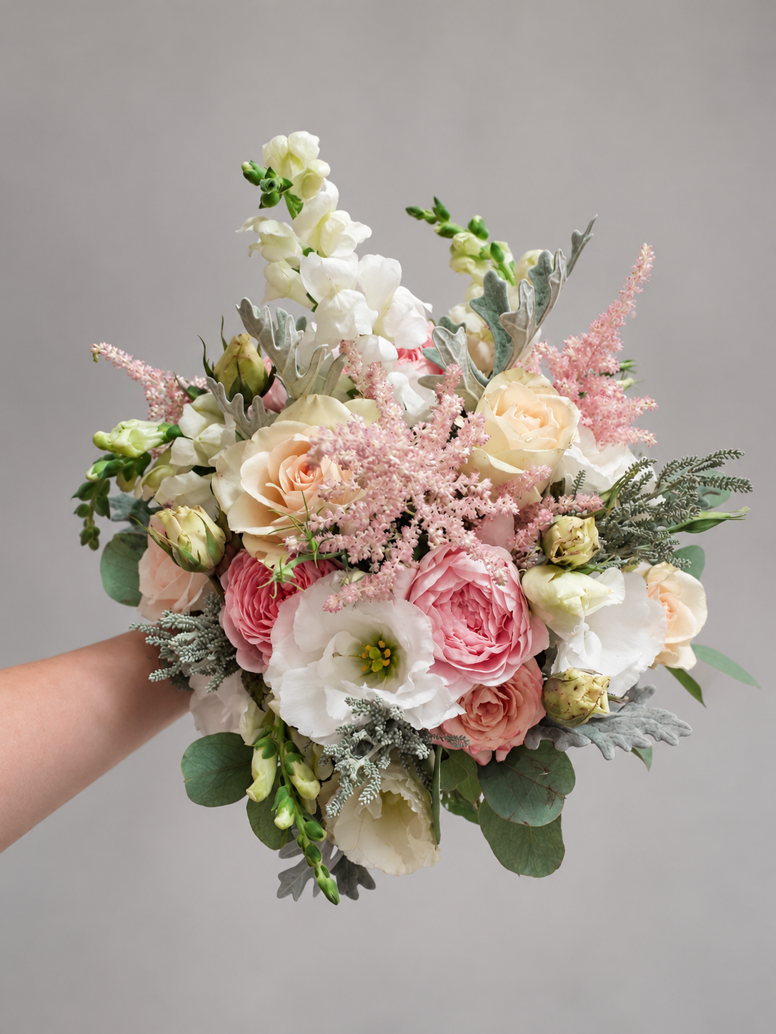 Blush and ivory bridal bouquet with roses, pink astilbe and silver foliage, view 2