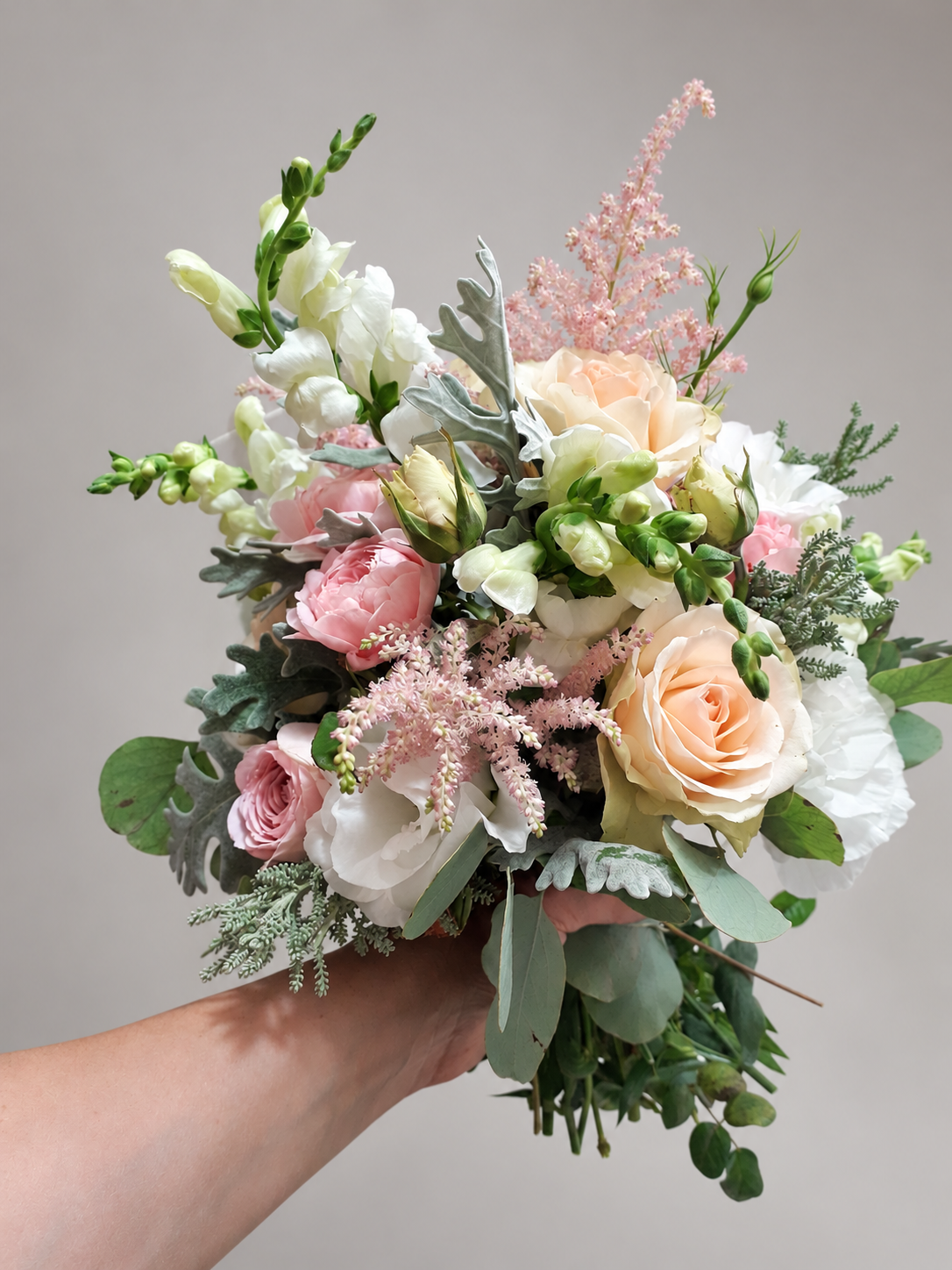 Blush and ivory bridal bouquet with roses, pink astilbe and silver foliage, view 3