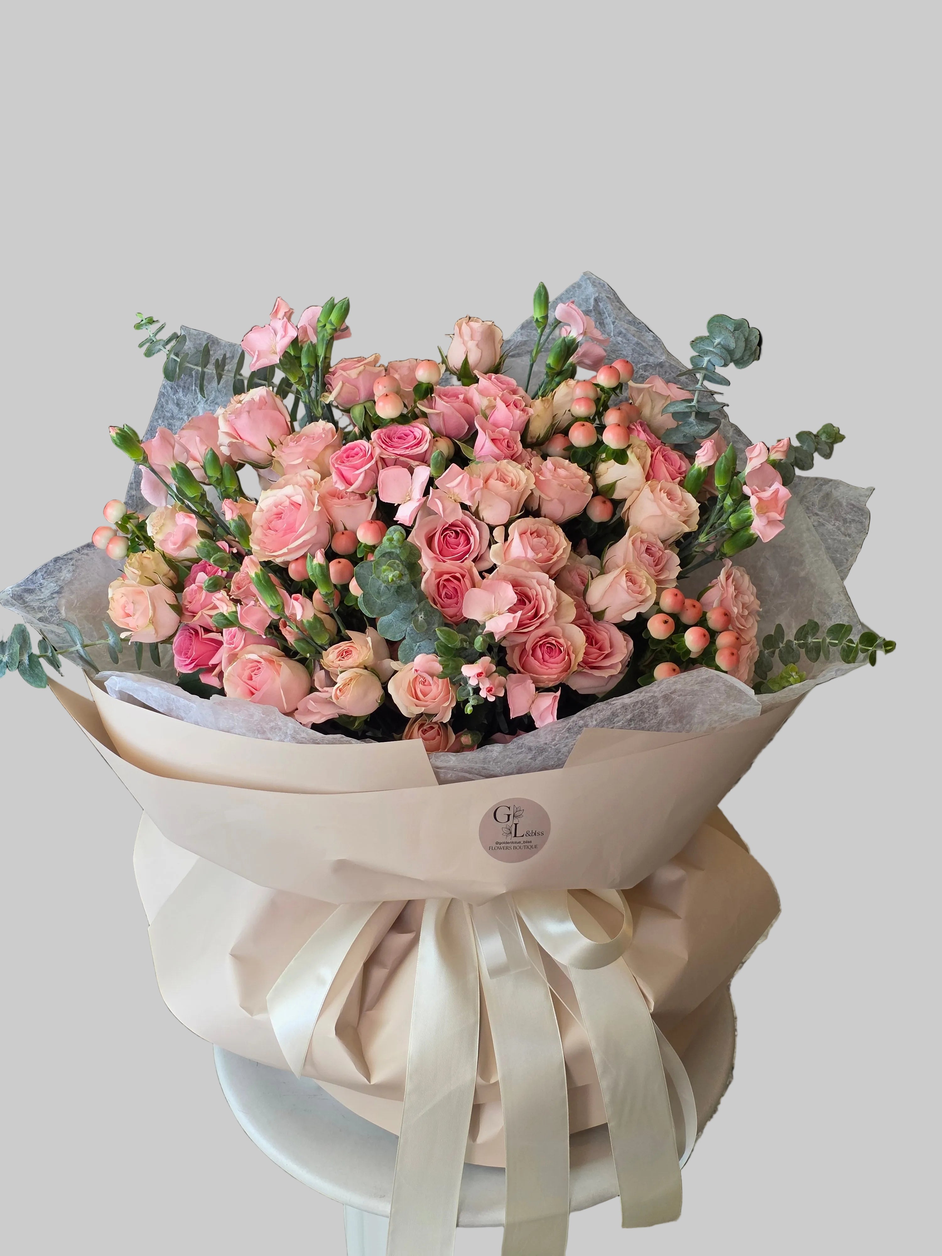 Blush garden bouquet with pink roses, spray roses, berries, and eucalyptus by Golden Lotus Bliss in Folsom California
