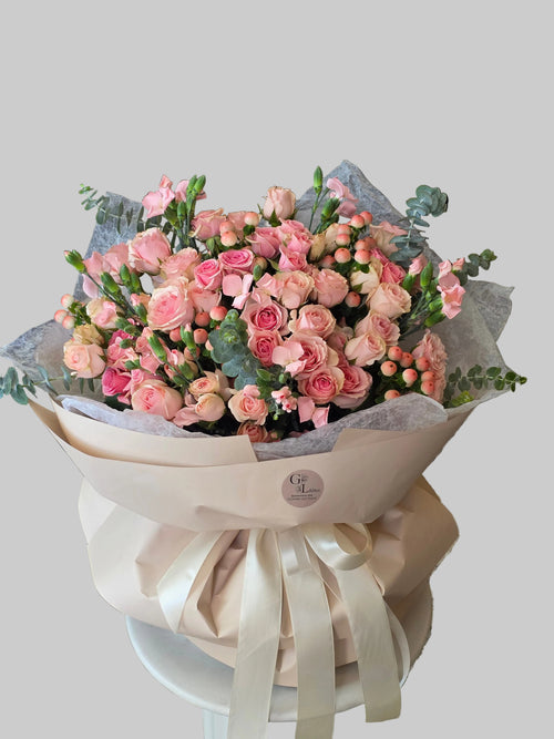 Blush garden bouquet with pink roses, spray roses, berries, and eucalyptus by Golden Lotus Bliss in Folsom California