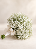 White baby's breath bridal bouquet in a warm ivory studio setting