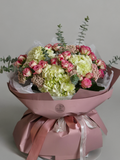 White hydrangea and pink spray rose bouquet with eucalyptus in blush wrapping