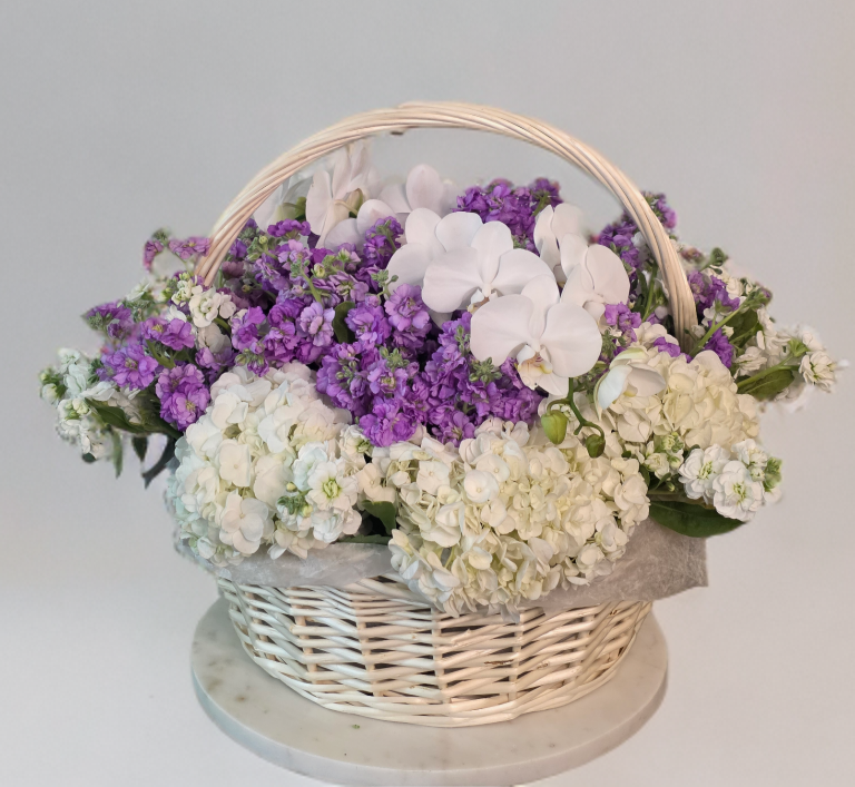 Luxury white and lavender flower basket with hydrangeas, purple stock and white Phalaenopsis orchids by Golden Lotus Bliss